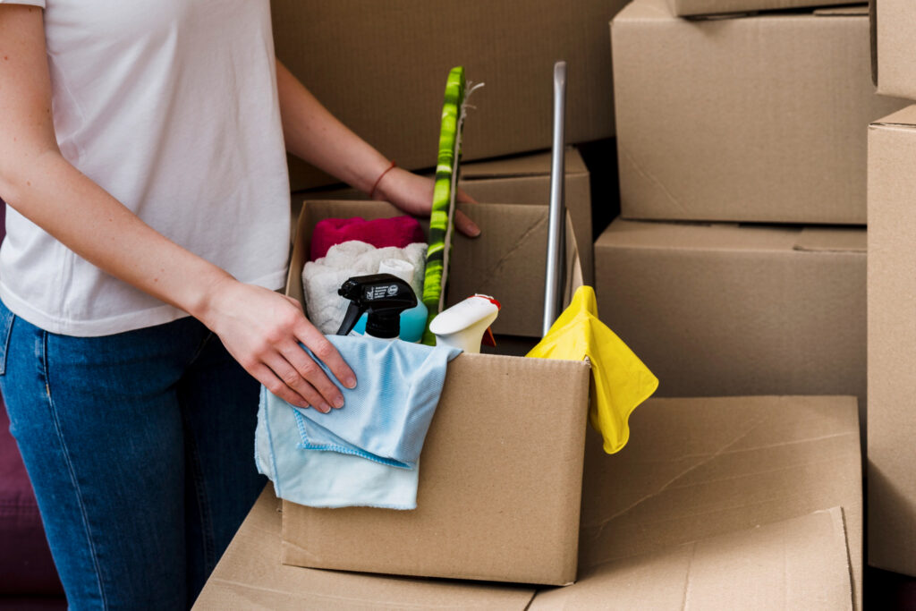 crop woman packing boxes