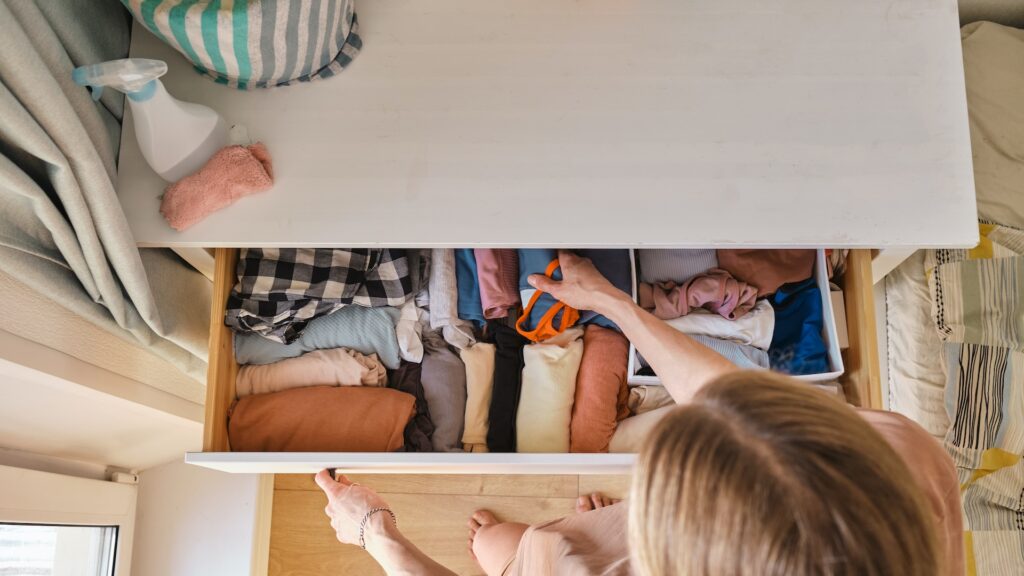 fixing clothes in cabinet drawer