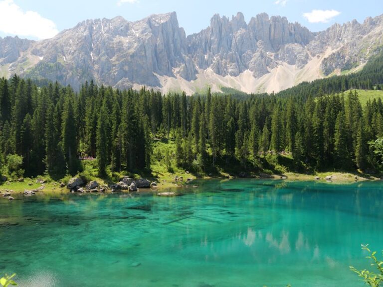 Breathtaking landscape of Karersee in South Tyrol with turquoise water and majestic Dolomite mountains.
